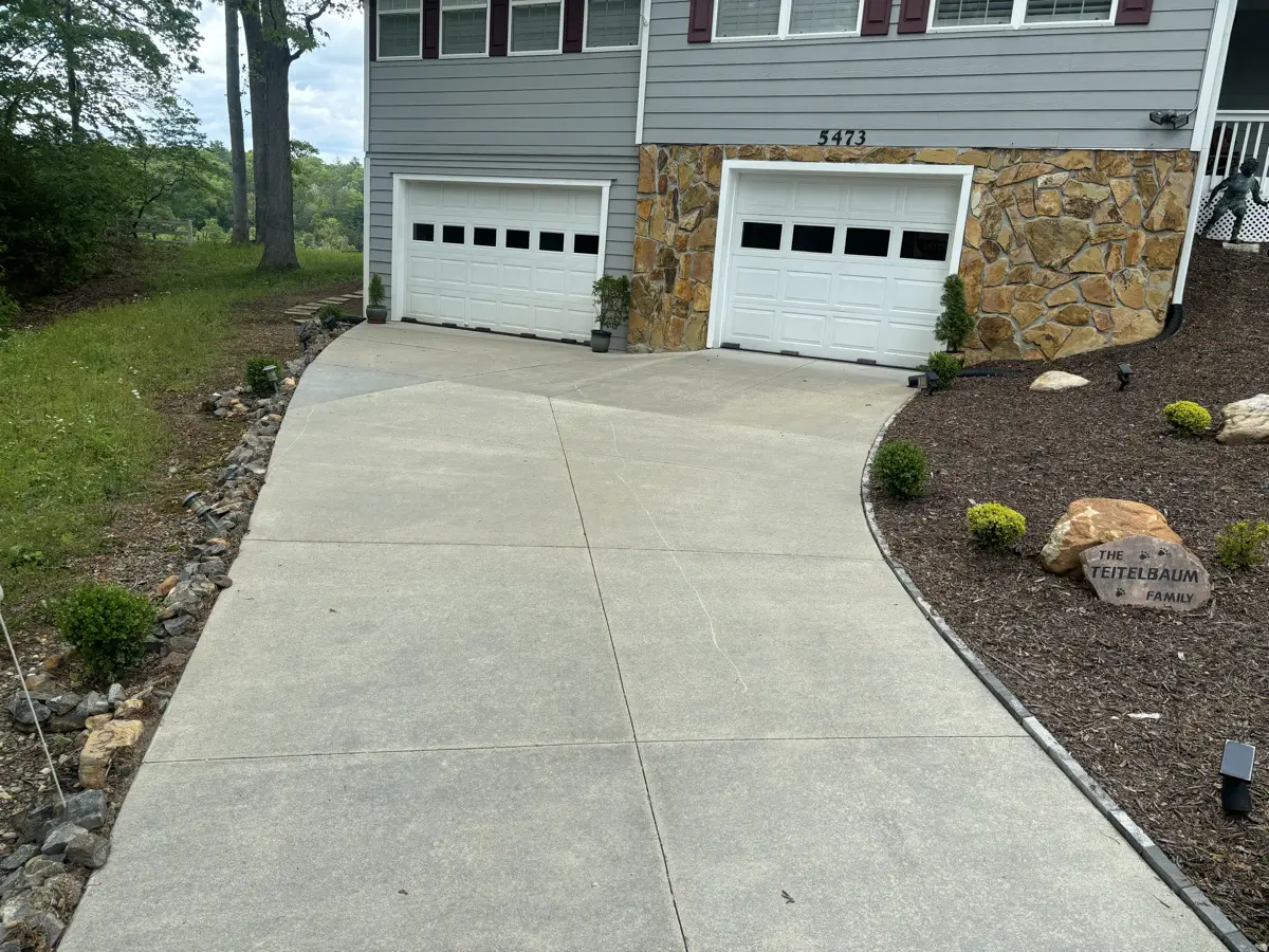 Brown driveway clean and restored after professional pressure washing