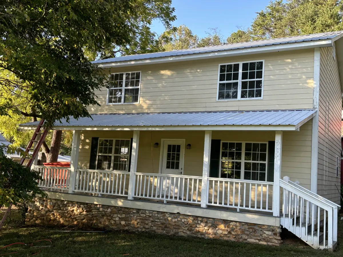 Yellow house exterior vibrant and spotless after pressure washing